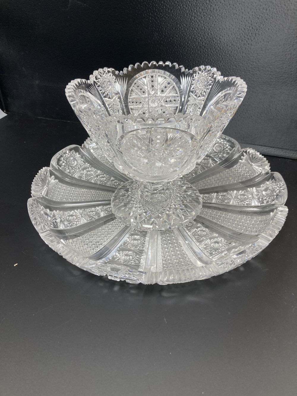 An American or Bohemian brilliant cut glass pedestal bowl and large dish, late 19th century, dish 36cm